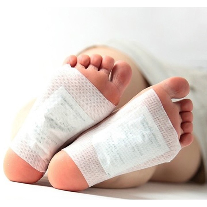 Two Vital plasters stuck to the soles of the feet